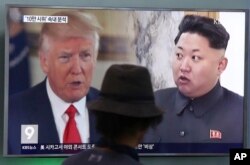 FILE - A man watches a television screen showing President Donald Trump and North Korean leader Kim Jong Un during a news program at the Seoul Train Station in Seoul, South Korea, Aug. 10, 2017.