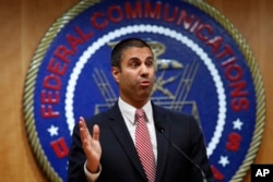 After a meeting voting to end net neutrality, Federal Communications Commission (FCC) Chairman Ajit Pai answers a question from a reporter,, Dec. 14, 2017, in Washington.