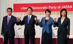 Candidates for the presidential election of the ruling Liberal Democratic Party pose prior to a joint news conference at the party's headquarters in Tokyo, Japan, Sept. 17, 2021. The candidates are, from left, Taro Kono, Fumio Kishida, Sanae Takaichi and Seiko Noda.