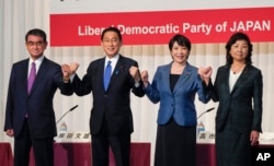 Candidates for the presidential election of the ruling Liberal Democratic Party pose prior to a joint news conference at the party's headquarters in Tokyo, Japan, Sept. 17, 2021. The candidates are, from left, Taro Kono, Fumio Kishida, Sanae Takaichi and Seiko Noda.