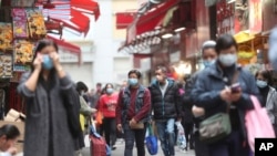 People wear masks at a market in Hong Kong, Feb, 3, 2020. 