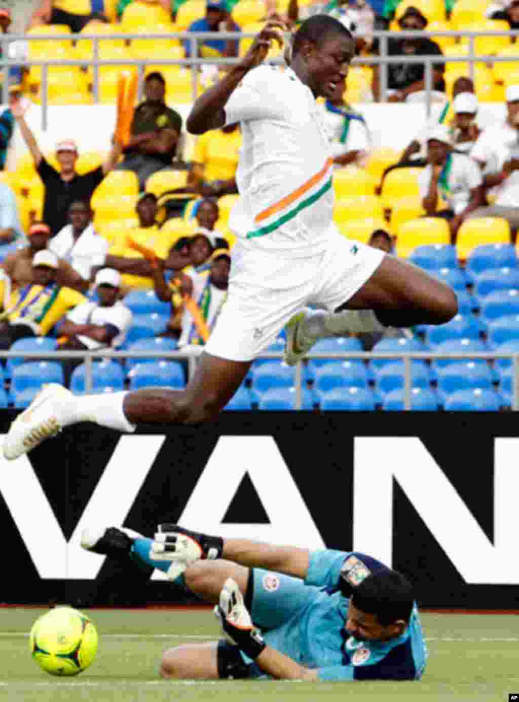 Niger's Moussa jumps over Tunisia's Ayem during their African Cup of Nations soccer match in Libreville