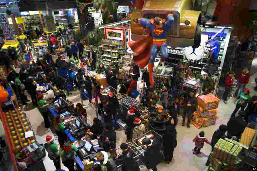 Customers wait on line to make their purchases at the Times Square Toys R' Us, New York, Nov. 28, 2013.