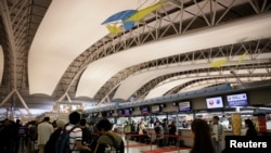 Travellers check-in at Kansai International Airport in Osaka, Japan October 28, 2017. REUTERS/Thomas White