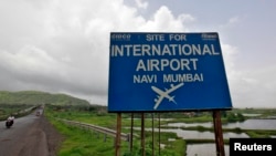 A signboard is pictured at the proposed site of Navi Mumbai airport, about 45 km (27 miles) east of Mumbai, August 8, 2012. 