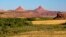 Seen in the distance are the twin buttes which gave the Bears Ears area its name. The are considered sacred to Navajo, Hopi and Ute tribal people and figure prominently in their traditional narratives. Courtesy, Bureau of Land Managment, Dept. of the Int