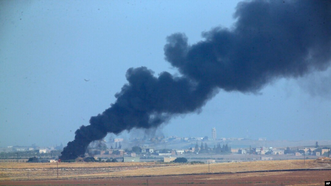 In this photo taken from the Turkish side of the border between Turkey and Syria, in Akcakale, Sanliurfa province, southeastern Turkey, smoke billows from a fire inside Syria during bombardment by Turkish forces, Oct. 9, 2019. 
