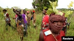 Members of the anti-balaka, a Christian militia, patrol outside the village of Zawa, Central African Republic, April 8, 2014. 