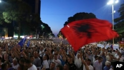 FILE - Anti-government protesters take part in a rally in Tirana, Albania, June 21, 2019. The opposition is boycotting the local elections planned for June 30 and has threatened to disrupt them.