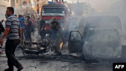 Syrians gather at the site of an explosion in the northeastern Kurdish city of Qamishli, Oct. 11, 2019. 