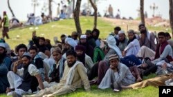 Protesters from Pakistan's Sunni Tehreek group sit in protest near the parliament building in Islamabad, Pakistan, March 30, 2016.