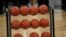 FILE - Basketballs sit in a rack during a game in Boulder, Colo., Jan. 23, 2020.