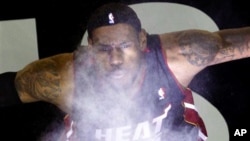 Miami Heat's LeBron James throws powder into the air prior before a game (file photo)