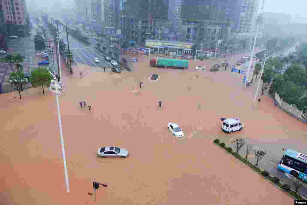 湖南长沙，暴雨中行人和车辆过马路（2017年7月1日）。湖南省防汛抗旱指挥部表示， 这轮强降雨总量之多、范围之广、强度之大、历时之长，洪峰水位之高、超过历史河段之多均为历年罕见。中国民政部向浙江、江西、湖南、贵州4省安排了7亿元中央财政自然灾害生活补助资金。