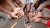 FILE: Opposition Movement for Democratic Change supporters hold spent rounds and show injuries after soldiers opened fire outside the party's headquarters in Harare, Zimbabwe, Aug. 1, 2018.