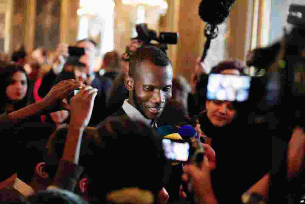 Lassana Bathily (tengah) imigran Mali yang menyelamatkan beberapa orang Yahudi yang mengunjungi pasar swalayan, berbicara dengan anak-anak di balai kota Paris (16/1). ​(AP/Thibault Camus)