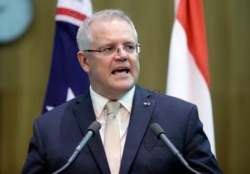 FILE - Australia's Prime Minister Scott Morrison makes a joint statement with Indonesia's President Joko Widodo at Parliament House, Feb. 10, 2020.