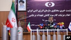 FILE - Atomic Energy Organization of Iran spokesman Behrouz Kamalvandi speaks during a news briefing with advanced centrifuges displayed in front of him, in Tehran, Iran, Sept. 7, 2019.