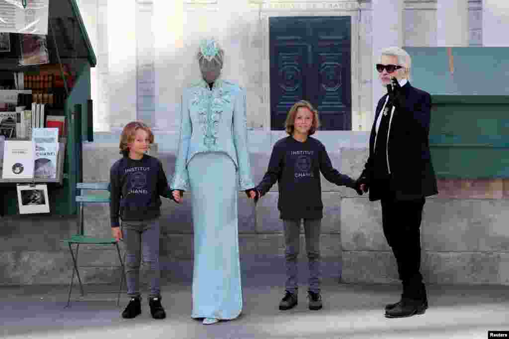German designer Karl Lagerfeld appears with model Hudson Kroenig and other models at the end of his Haute Couture Fall/Winter 2018/2019 collection show for fashion house Chanel at the Grand Palais in Paris, France.