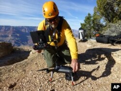 A Grand Canyon National Park employee operates a drone at the park in 2016. The Grand Canyon is the only national park with its own fleet of unmanned aircraft for reaching people who have gotten lost, stranded, injured or killed.