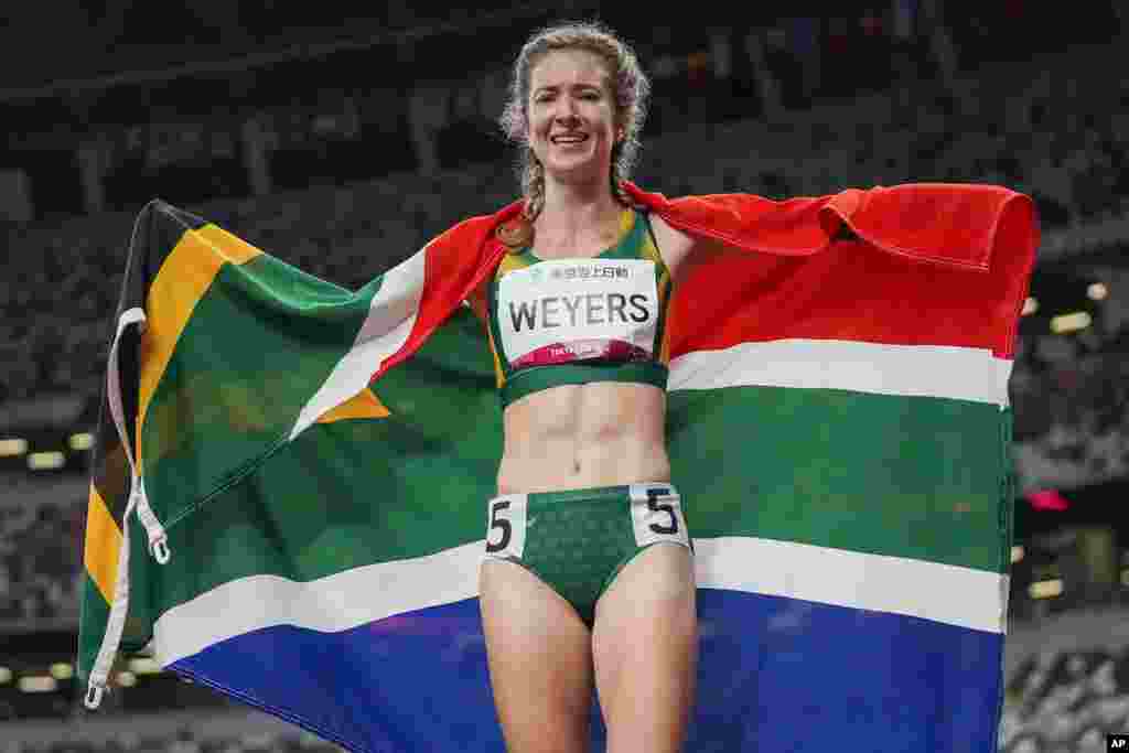 South Africa&#39;s Anrune Weyers celebrates after winning the women&#39;s T47 400-meters final during the 2020 Paralympics at the National Stadium in Tokyo. (AP Photo/Eugene Hoshiko)