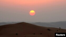 FILE - The sun sets in the Rub' al-Khali desert, which encompasses most of the southern third of the Arabian Peninsula. One reason that such regions are so dry is that they lack vertical movement of moist air.