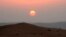 FILE - The sun sets in the Rub' al-Khali desert, which encompasses most of the southern third of the Arabian Peninsula. One reason that such regions are so dry is that they lack vertical movement of moist air.