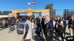 US ambassador to Egypt Herro Mustafa Garg (C-L) and US Senator Jeff Merkley (C-R), along with a US delegation, visit the Egyptian side of the Rafah border crossing on January 5, 2024.