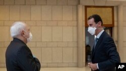 모하마드 자바드 자리프 이란 외무장관(왼쪽)이 20일 시리아를 방문하고, 바샤르 알 아사드 대통령을 면담했습니다.
