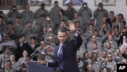 President Barack Obama waves to U.S. service members after being introduced at a Veteran's Day event at U.S. Army Garrison Yongsan in Seoul, South Korea, 11 Nov 2010