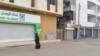 A woman walks past two closed banks in a deserted street in Sudan's capital Khartoum, Sudan, June 4, 2019.