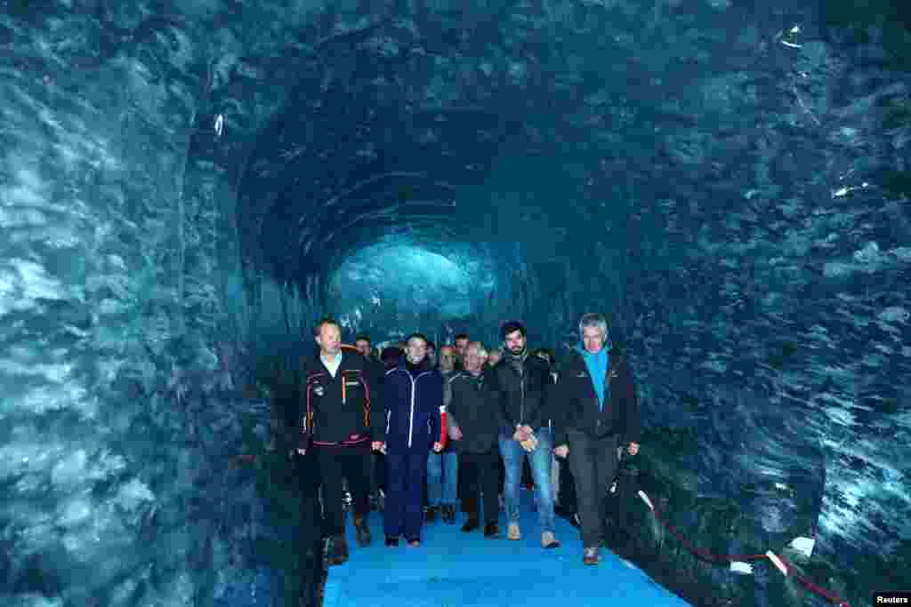 French President Emmanuel Macron, accompanied by Compagnie du Mont-Blanc CEO Mathieu Dechavanne and glaciologist Luc Moreau, visits the &quot;Mer de Glace&quot;, the country&#39;s largest glacier, which has shrunk dramatically in recent years, in Chamonix.