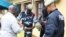 Police question detained Muslim retail traders on Dec. 17, 2017 in Libreville, following a knife attack on two Danish nationals. 