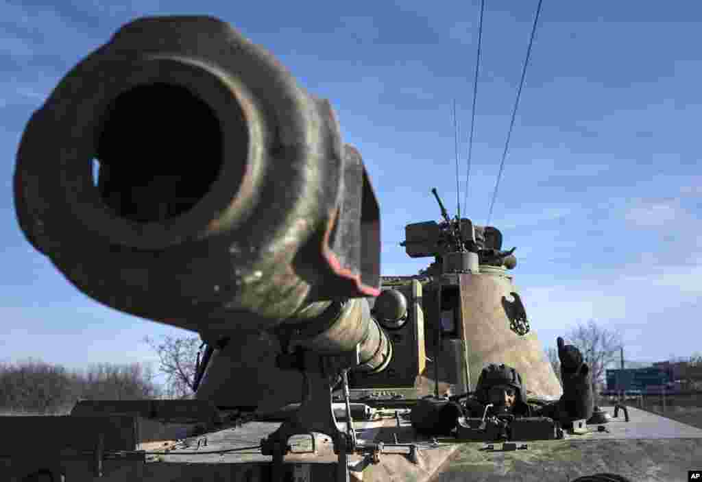 A Ukrainian soldier rides a self-propelled artillery piece near Artemivsk, eastern Ukraine, Feb. 23, 2015.