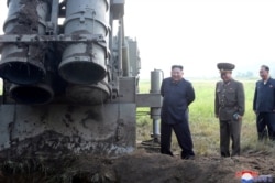 FILE - North Korean leader Kim Jong Un attends the testing of a super-large multiple rocket launcher in North Korea, in this undated photo released Sept. 10, 2019, by North Korea's Korean Central News Agency.