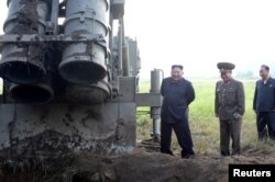 FILE - North Korean leader Kim Jong Un attends the testing of a super-large multiple rocket launcher in North Korea, in this undated photo released Sept. 10, 2019 by North Korea's Korean Central News Agency.