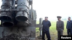 FILE - North Korean leader Kim Jong Un attends the testing of a super-large multiple rocket launcher in North Korea, in this undated photo released Sept. 10, 2019 by North Korea's Korean Central News Agency. 