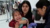 A Venezuelan girl cries while receiving a measles vaccine at an immigration processing office on the Rumichaca bridge, after crossing the border from Colombia to Ecuador, June 13, 2019.