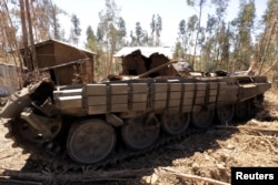 FILE - A tank destroyed during fighting between the Ethiopian National Defense Force (ENDF) and the Tigray People's Liberation Front (TPLF) forces is seen on a roadside in Gashena, Amhara region, Ethiopia, Dec. 7, 2021.