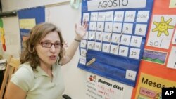 FILE - Unidos Dual Language Charter School teacher Rosa Pellicer talks about her class in Forest Park, Georgia, Monday, Aug. 21, 2006. (AP Photo/Ric Feld)