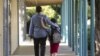 FILE - In this 2012 photo, a father walks his son, who is autistic, to the Nestle Avenue Elementary School in Los Angeles.