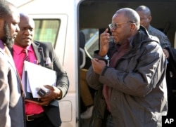 FILE: Zimbabwean opposition official Tendai Biti arrives at the magistrates courts in Harare, Thursday Aug. 9, 2018. Biti was deported to Zimbabwe following his arrest in Zambia after his asylum bid was rejected.