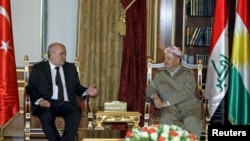 Iraqi Kurdish Regional President Massoud Barzani (R) meets with Turkish Foreign Minister Feridun Sinirlioglu (L) in Irbil, Iraq, Nov. 4, 2015.