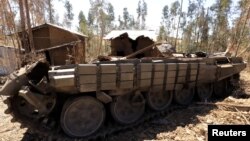 A tank destroyed during fighting between the Ethiopian National Defense Force (ENDF) and the Tigray People's Liberation Front (TPLF) forces is seen on a roadside in Gashena, Amhara region, Ethiopia Dec. 7, 2021.