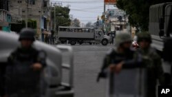 FILE - Marines block the area where a suspected drug gang leader and seven others were killed, according to the Navy, in the Tlahuac neighborhood of Mexico City, July 20, 2017. 