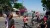 Merchants leave the area after gunshots were heard in Port-au-Prince, Haiti, on March 20, 2024.