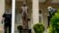 Bullet holes are visible on a column behind a statue of Cuban independence hero José Martí as Secret Service officers investigate after police say a person with an assault rifle opened fire at the Cuban Embassy, April 30, 2020, in Washington.