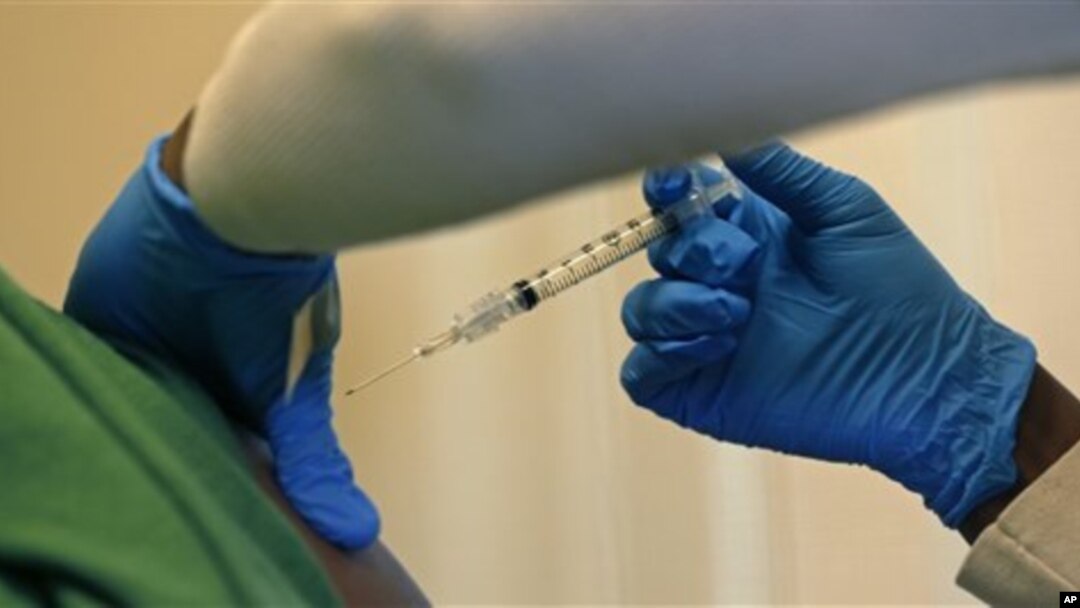 Registered nurse Charlene Luxcin administers a flu shot to a patient at the Whittier Street Health Center in Boston, Massachusetts, January 9, 2013. Boston declared a public health emergency Wednesday. 
