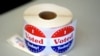 FILE - A spool of stickers rests on a table at a polling station during Massachusetts state primary voting, Sept. 3, 2024, in Newton, Mass.