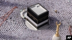 FILE - Muslim pilgrims pray around the Kaaba, the cubic building at the Grand Mosque, during the annual Hajj pilgrimage in Mecca, Saudi Arabia, on June 25, 2023. (AP Photo/Amr Nabil, File)